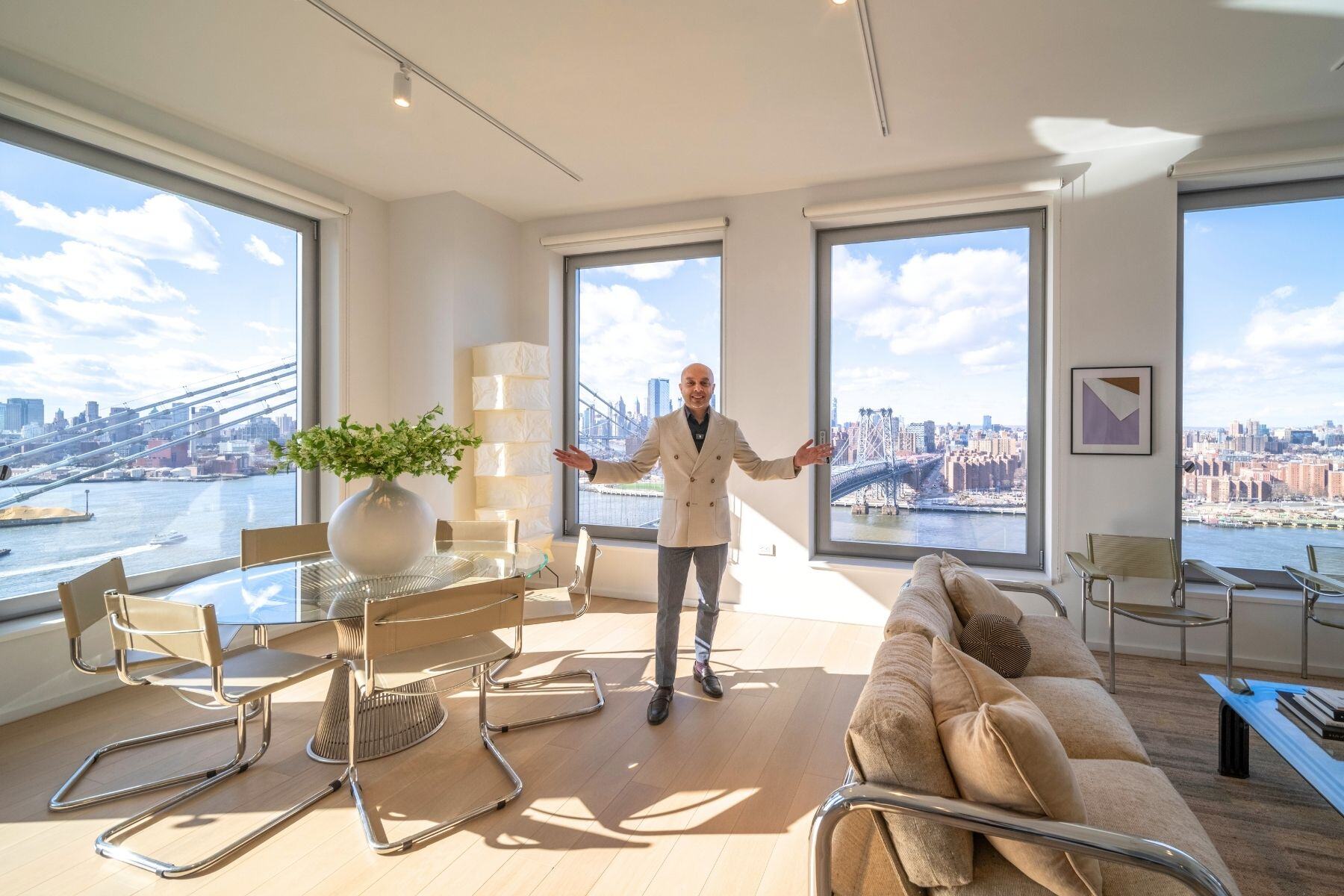 Mukul standing inside condo at One Domino Square
