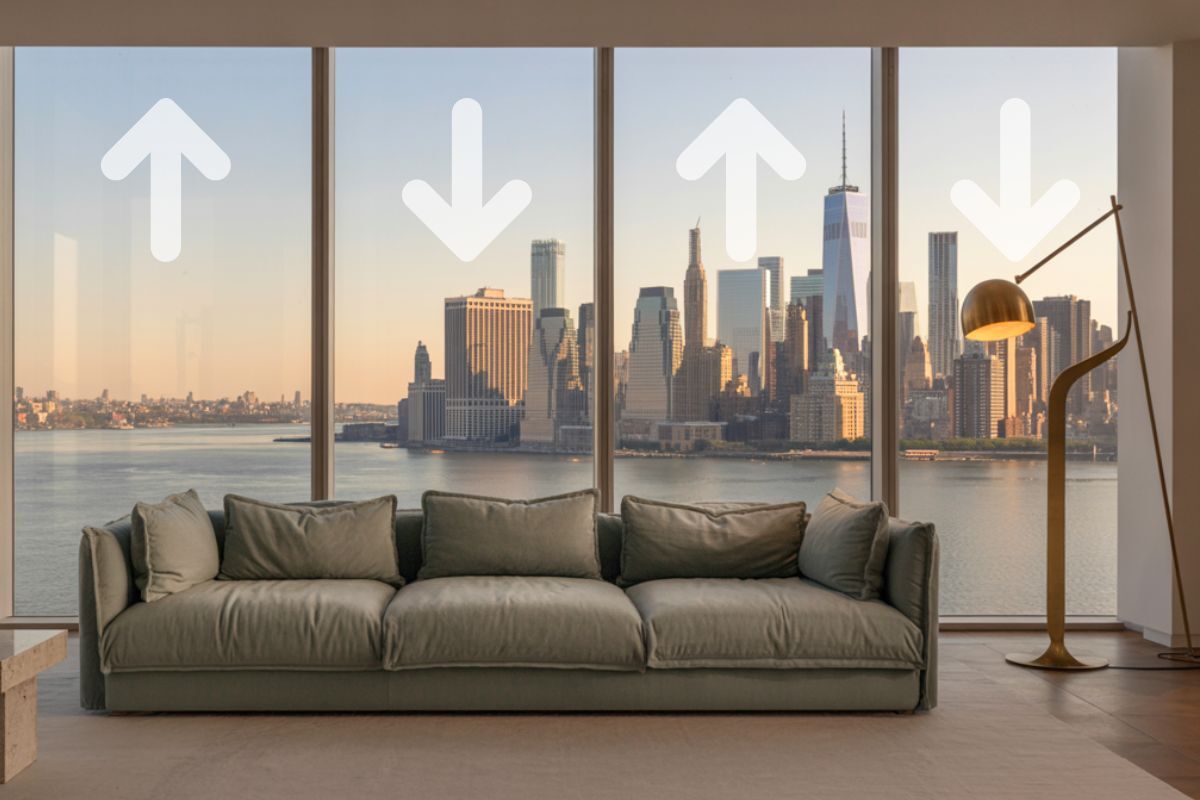 Market shift arrows on window in NY condo overlooking the city skylin